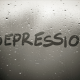 depression written on rainy window