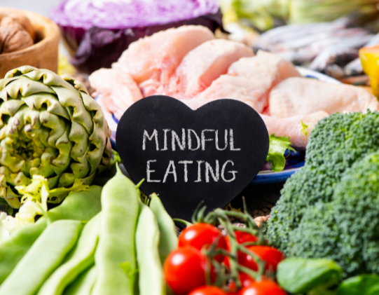 colorful food around a mindful eating sign